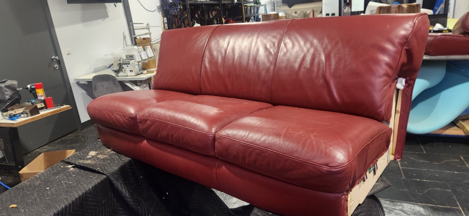 The finished red leather Natuzzi lounge after re-webbing, new high-density foam and leather touch-ups