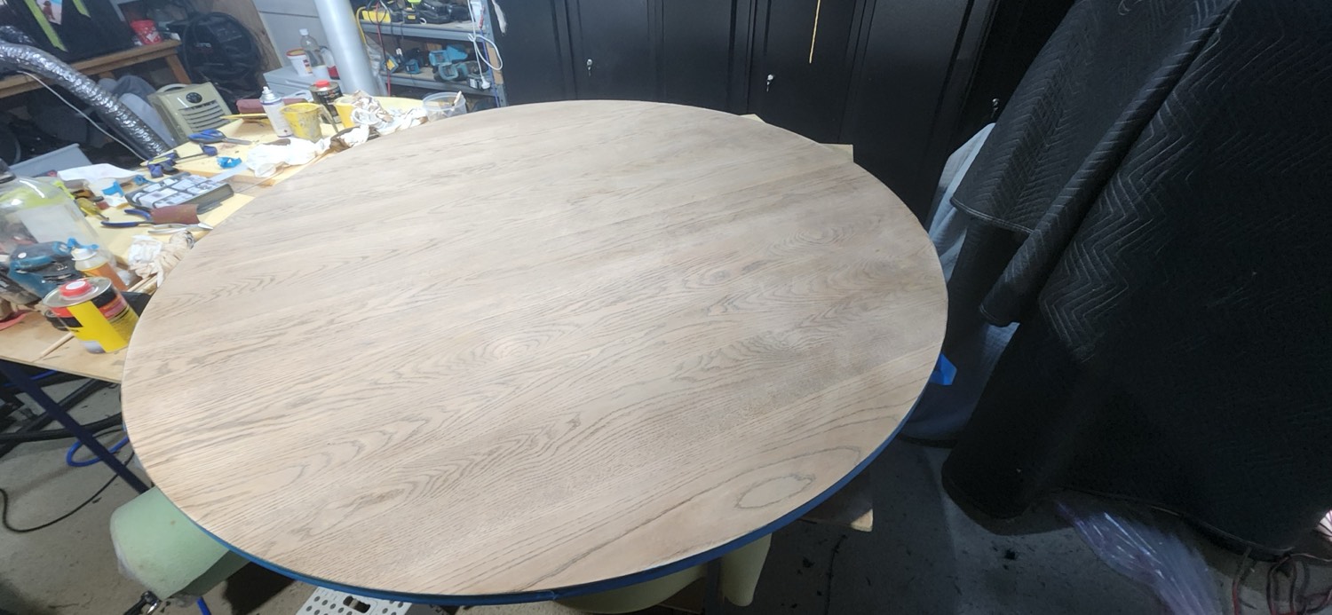 Round oak dining table top stripped and sanded back to bare timber in the Dylberry workshop